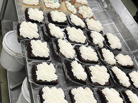 Trays of iced brownies packaged for pickup